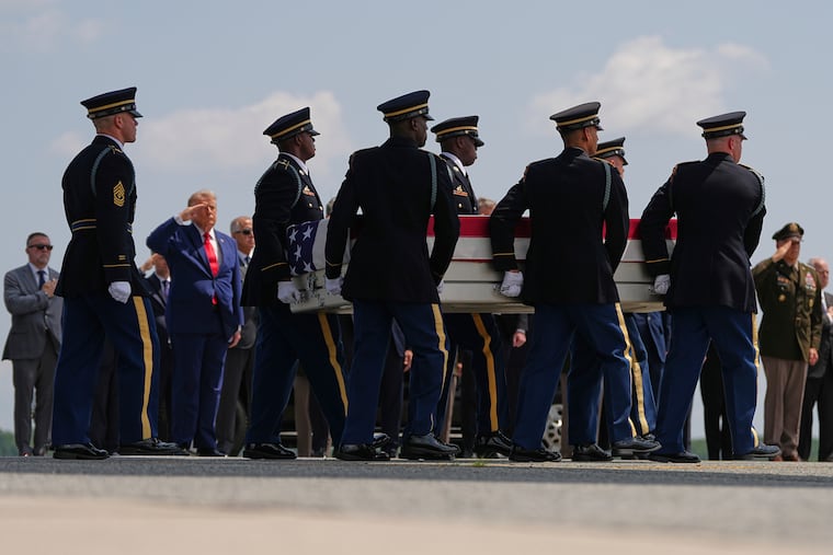 President Donald Trump salutes as a U.S. Army carry team moves a transfer case containing the remains of Pvt. Isabella Gonzales, 19, of Carrollton, Texas, on Wednesday at Dover Air Force Base, Del.