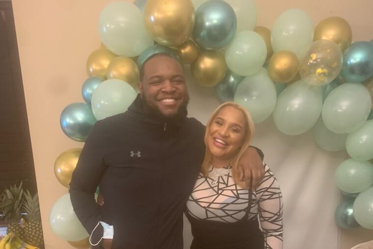 Hyram Hill with an aunt in an undated family photo. HIll, the son of a Philadelphia police officer, was killed during a North Philly street robbery on Jan. 24.