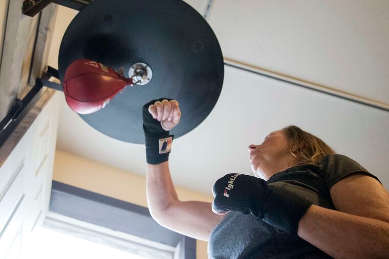 Lorraine Duffey, 61, who has Parkinson's disease, works on the speed bag during a therapeutic boxing class at Joltin' Jabs. Program participants report less depression and more mobility.