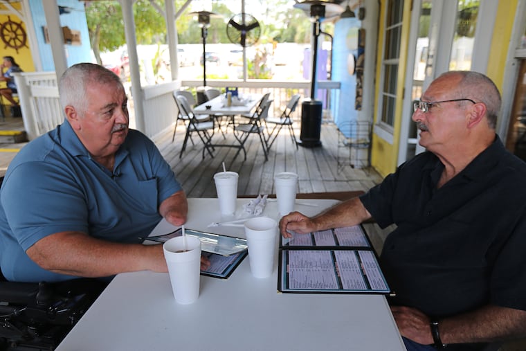 Dennis Joyner (left) has lunch with Dewey "Doc" Hayes, at the Old Florida Grill & Oyster House in Cocoa, Fla., on Friday, March 15, 2019. Joyner lost both legs and his left arm when he stepped on a landmine while fighting the war in Vietnam, 50 years ago. He credits his field medic, Hayes, for saving his life, and 50 years he thanked him in person. (Ricardo Ramirez Buxeda / Orlando Sentinel / TNS)