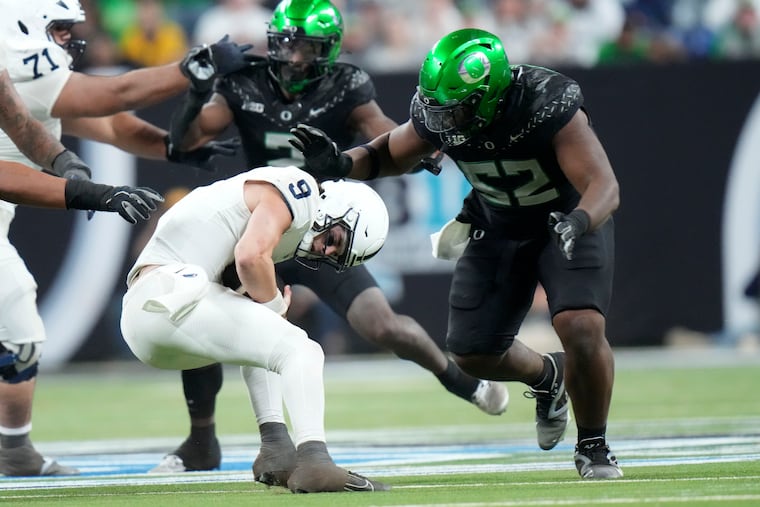 Penn State quarterback Beau Pribula is sacked by Oregon defensive lineman A'Mauri Washington (52) during the second half of the Big Ten championship.