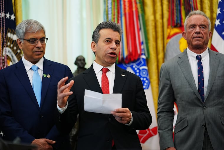 Marty Makary, commissioner of the Food and Drug Administration (center), speaks while National Institutes of Health Director Jay Bhattacharya and Health and Human Services Secretary Robert F. Kennedy Jr. listen in the Oval Office of the White House, Saturday, April 18, 2026, in Washington.