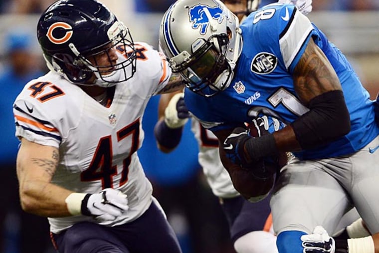 Detroit Lions wide receiver Calvin Johnson (81) is tackled by Chicago Bears free safety Chris Conte (47) and inside linebacker Jon Bostic (57) during the first quarter at Ford Field. (Andrew Weber/USA Today)