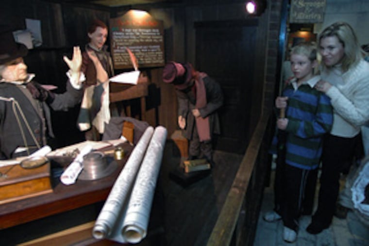 Before an animatronic scene from Dickens' "A Christmas Carol" at Macy's are visitors Billy Murphy, 10, of Malvern, and his mother, Patti. The display was created in 1984 for Strawbridge & Clothier.