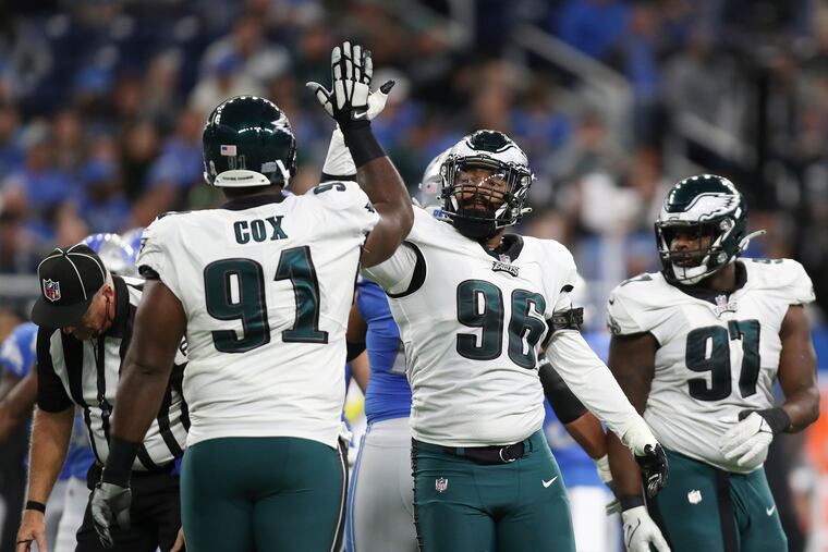 Eagles defensive end Derek Barnett (center) celebrating his second-quarter sack, on Detroit Lions quarterback Jared Goff, with defensive tackle Fletcher Cox on Sunday in Detroit.