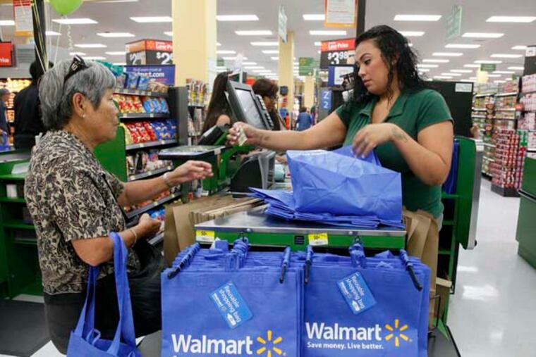 Consumers shop at the new Walmart Neighborhood Market, opening its 34,000 square foot store in the Chinatown district of Los Angeles Thursday, Sept. 19, 2013. (AP Photo/Nick Ut)