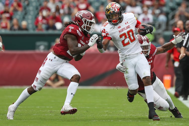 Temple's Harrison Hand (23), left, and Chapelle Russell bring down Maryland running back Javon Leake in the first quarter of a game at Lincoln Financial Field last September.