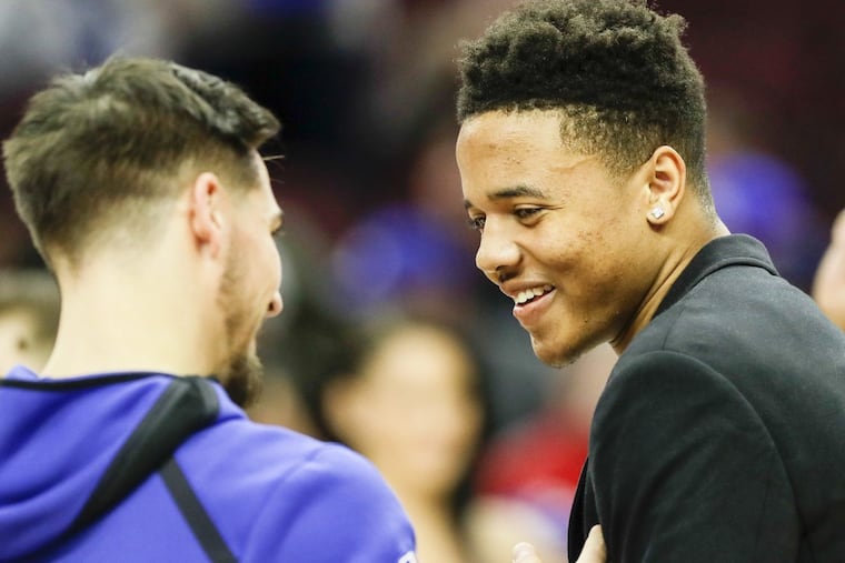 Injured Sixers guard Markelle Fultz, right, is still weeks away, at least, from returning to the Sixers lineup. YONG KIM / Staff Photographer
