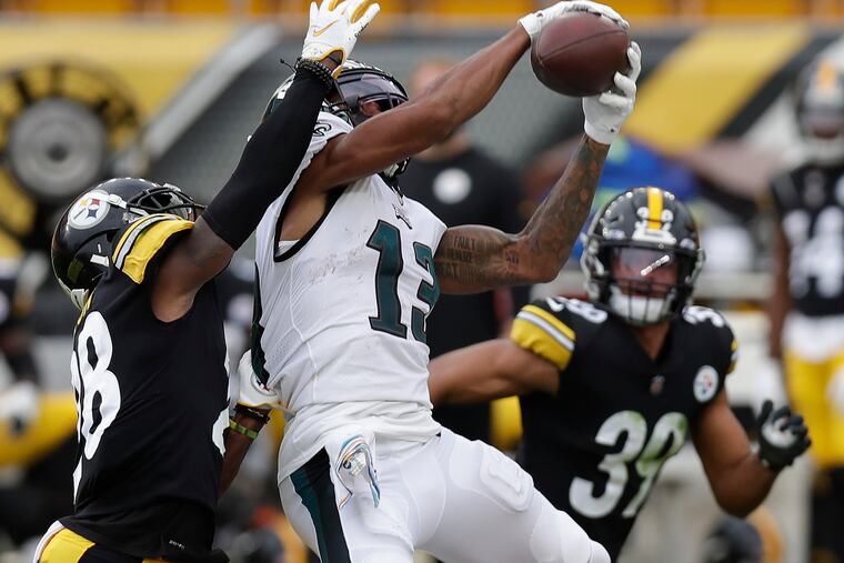 Eagles wide receiver Travis Fulgham catches the football past Pittsburgh Steelers cornerback Mike Hilton (left) and free safety Minkah Fitzpatrick during the third quarter of Sunday's 38-29 loss.
