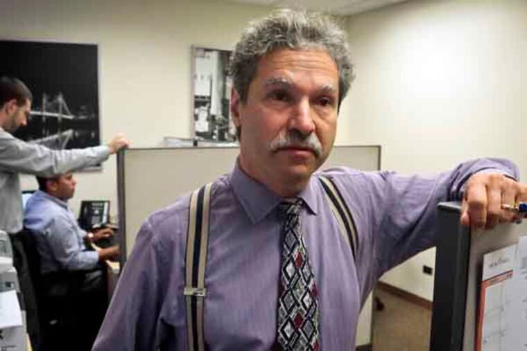 In this Tuesday, Aug. 27, 2013 photo, David Rosenbaum, president of Real-Time Computer Services, listens as he confers with office staff in New York. Rosenbaum says that keeping costs down should remain a priority for companies because customers are willing to bolt to another business that offers lower prices. (AP Photo/Bebeto Matthews)