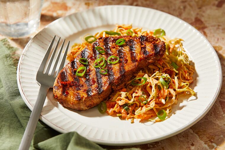 Chili Crisp Pork Chops With Kimchi Slaw. MUST CREDIT: Tom McCorkle for The Washington Post; food styling by Gina Nistico for The Washington Post
