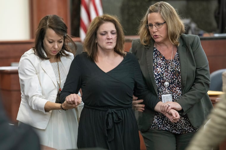 CORRECTS TOWN TO COLUMBIA NOT LEXINGTON - Amber Kyzer is helped out of the courtroom after breaking down on the witness stand while being questioned during the trial of her ex-husband, Tim Jones, in Columbia, S.C., Monday, May 20, 2019. Timothy Jones, Jr. is accused of killing their 5 young children in 2014. Jones, who faces the death penalty, has pleaded not guilty by reason of insanity. (Tracy Glantz/The State via AP, Pool)