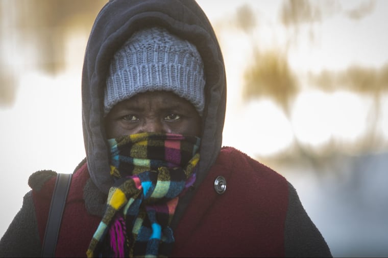 Linda A. Sandi of Philadelphia makes her way along 17th Street near Callowhill Street on a cold Sunday morning.