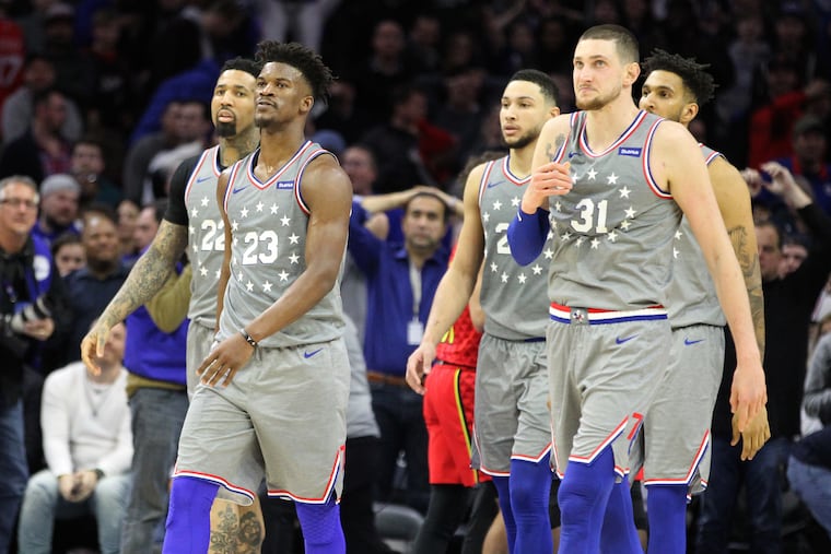The Sixers, including Jimmy Butler, 2nd from left, walk off the court after their 123-121 loss to the Hawks on Jan. 11, 2019. Butler missed 2 free throws that would have tied the game.