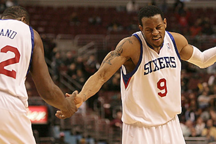 Andre Iguodala and Elton Brand celebrate a stop in overtime against the Bulls. The Sixers beat the Bulls, 106-103. (Yong Kim / Staff Photographer)