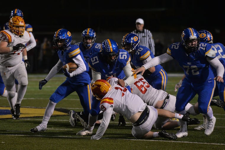 Alex Rosano (6) of Downingtown West following the block of teammate Drew Shelton (51) in the District 1 Class 6A semifinals vs. Haverford High. Downingtown West won the game, 49-42.