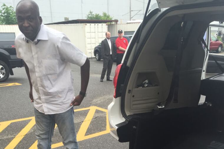 Camel Fofana shows off his cab that accommodates wheelchairs. (Erin Edinger-Turoff / Staff)