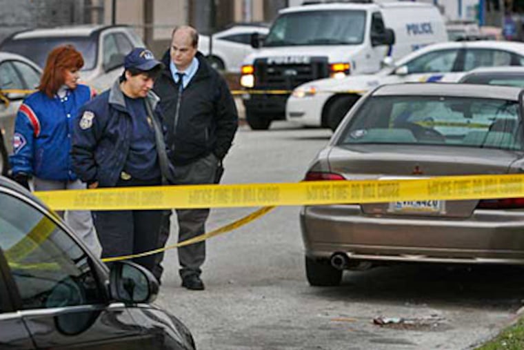 Crime scene officers early this morning examine the scene along the 6000 block of Keystone Street where a man was fatally shot behind the wheel of his minivan. (ALEJANDRO A. ALVAREZ / Staff photographer )