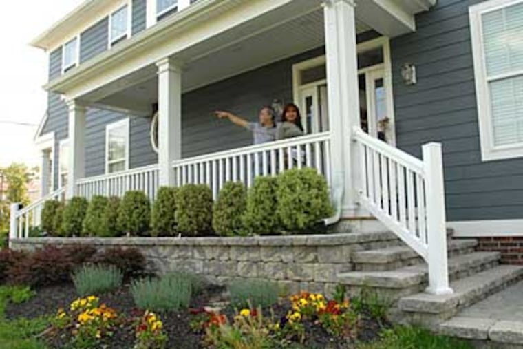 Victor Marrero and fiancee Milagros Rivera look out in May 2008, from the 'Extreme Makeover' home. He now has a buyer.