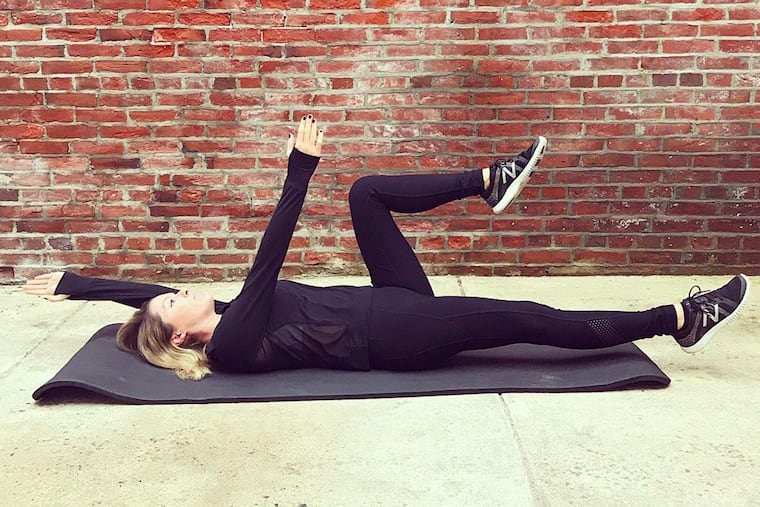 Ashley Greenblatt demonstrates the dead bug exercise.