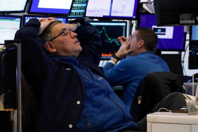 A pair of traders work in their booth on the floor of the New York Stock Exchange.