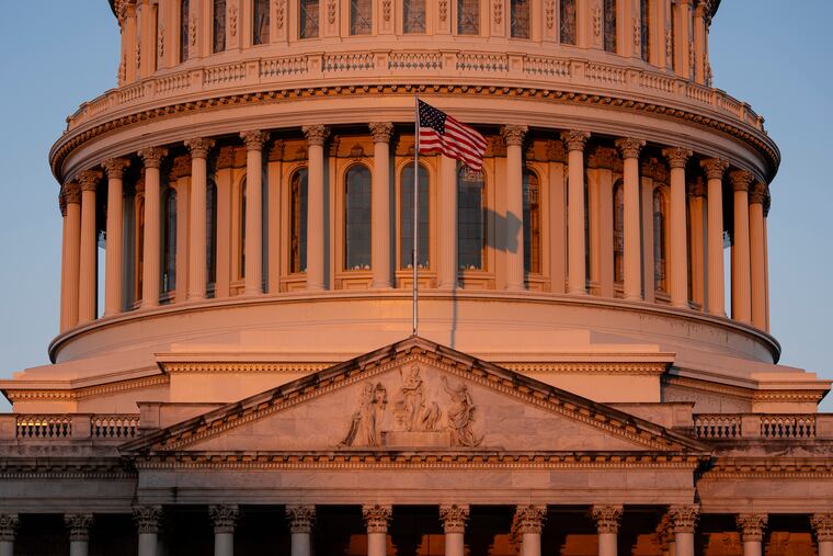 The Capitol is illuminated at dawn in Washington on Monday, Oct. 6.