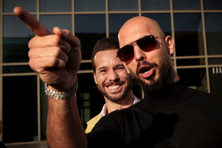 Andrew Tate, next to his brother Tristan, gestures outside the Bucharest Tribunal in Bucharest, Romania, on Thursday, Jan. 9, 2025.