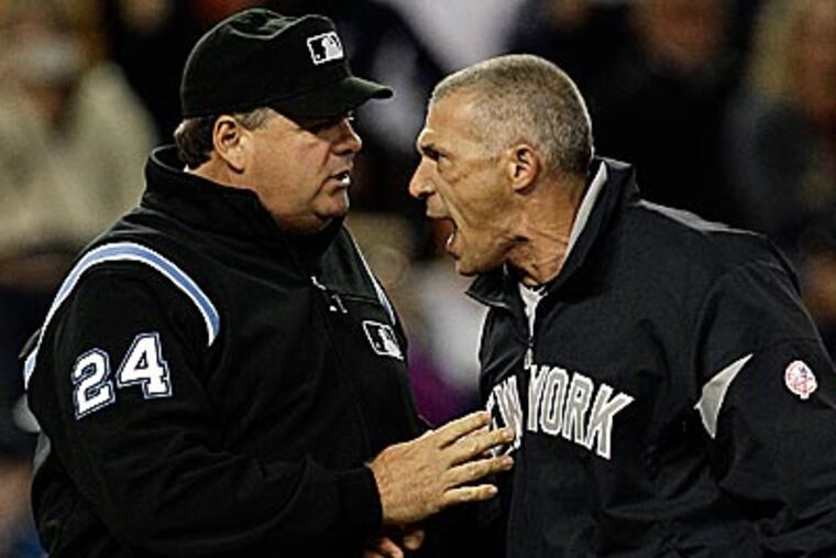Yankees manager Joe Girardi argues with umpire Bob Davidson on Saturday. (Paul Sancya/AP)