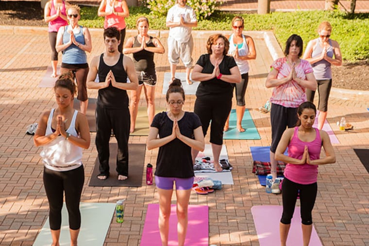 90 people participate in outdoor yoga practice, put on by King of Prussia District and Stillpoint Yoga Studio, held outside the Maschellmac Office Complex on June 24, 2014. ( MATTHEW HALL / Staff Photographer )
