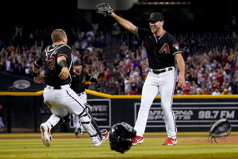 Arizona Diamondbacks starting pitcher Tyler Gilbert, right, celebrates after his no-hitter in a baseball game against the San Diego Padres with catcher Daulton Varsho, Saturday, Aug. 14, 2021, in Phoenix. It was Gilbert's first career start. The Diamondbacks won 7-0. (AP Photo/Matt York)