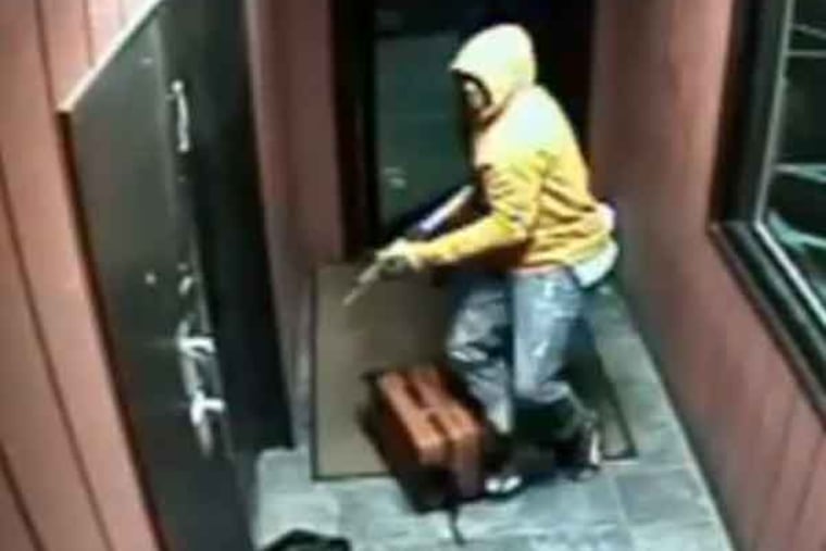 Surveillance video shows Suspect #1 entering the club with an AK-47.