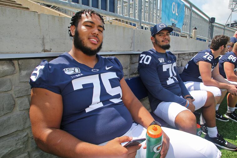 Penn State football offensive linemen Des Holmes (75) and Juice Scruggs (70) during the program's annual Media Day on Aug. 3, 2019.