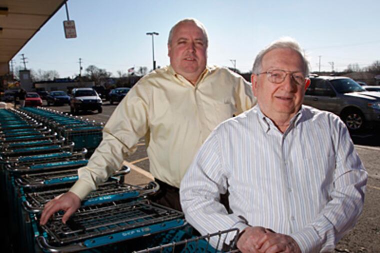 Shop n Bag owner Murray Battleman (right), with store manager John Brown, maintains that a Giant supermarket that is part of the proposal would hurt his business badly. (Laurence Kesterson / Staff Photographer)