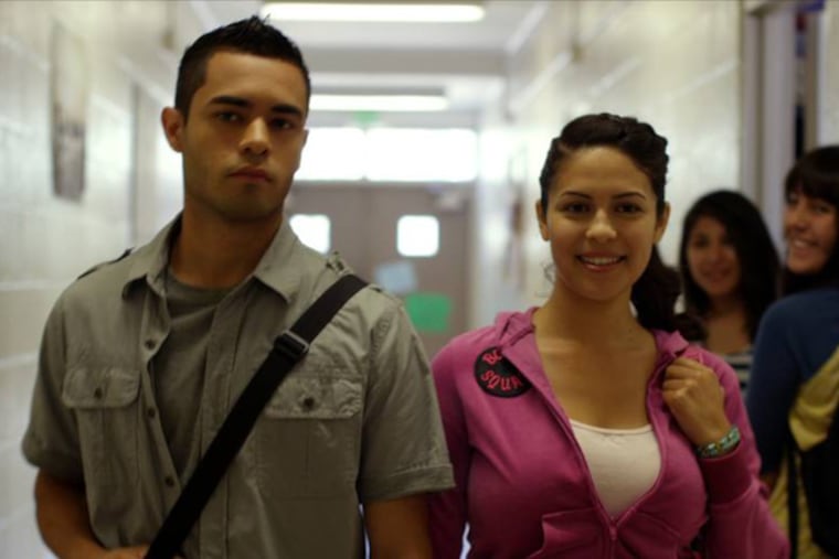 Janine Larina as Jessie Martinez and Gabriel Chavarria as Jacob Aguilar walk through a hallway on "East Los High."