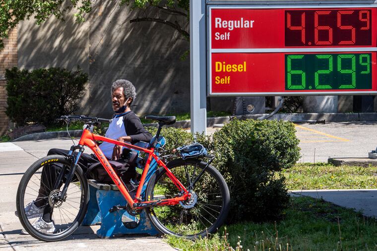 An unidentified man near the advertised gas prices at a Sunoco Station on Ridge Avenue in Philadelphia.