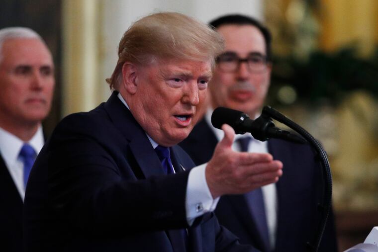 President Donald Trump, gestures as he and Chinese Vice Premier Liu He prepare to sign a U.S. China trade agreement, in the East Room of the White House, Wednesday, Jan. 15, 2020, in Washington.