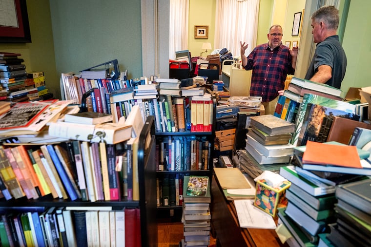 John Romani (left), owner of Sales by Helen, and John Karpinski talk about organizing the Rittenhouse Square estate.