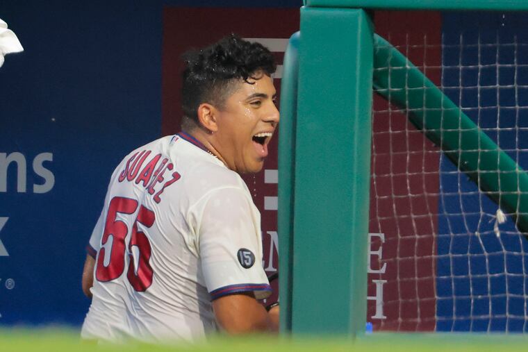 Ranger Suárez reacts after teammates doused him with a cooler full of water after he shut out the Pirates on Saturday.