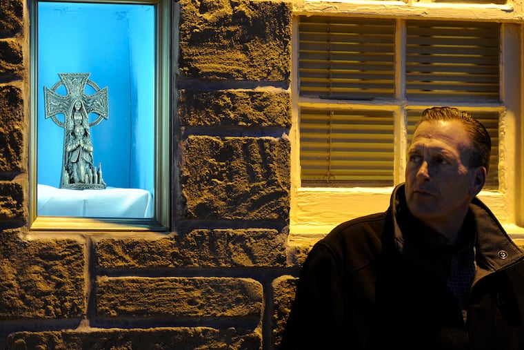 Bill Provence goes outside following the nightly mass in the former funeral home, now called the Matt Talbot House after the Irish ascetic. Though not formally recognized as a saint, The Venerable Matt Talbot is considered a patron of those struggling with alcoholism.