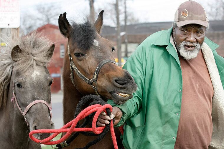 Ellis Ferrell with his little ponies Cocoa (left) and Babbles. ELIZABETH ROBERTSON / Staff Photographer
