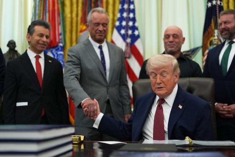 President Donald Trump shakes hands with U.S. Secretary of Health and Human Services Robert Kennedy Jr. in the Oval Office of the White House, Saturday, April 18, 2026, in Washington. (AP Photo/Julia Demaree Nikhinson)