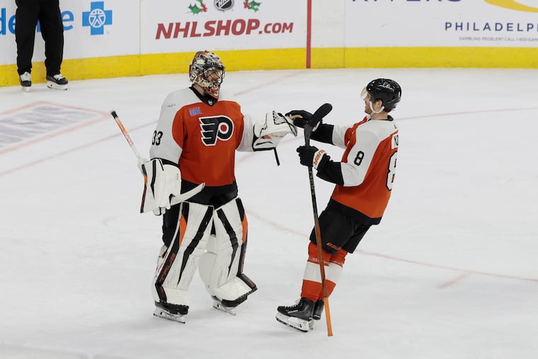 Flyers goalie Samuel Ersson and teammate Cam York celebrate the Flyers 1-0 victory over the Detroit Red Wings at the Wells Fargo Center on Dec. 16.