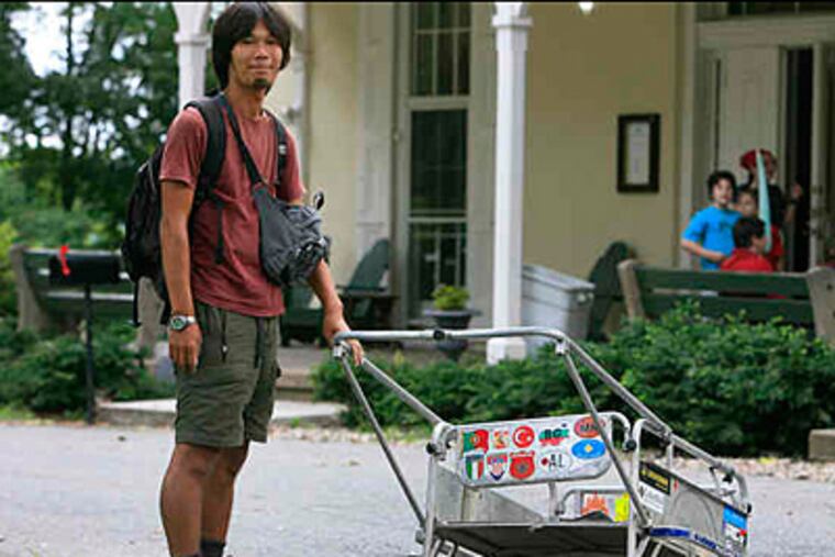 'Planet' walker Masahito Yoshida in Fairmount Park with his cart. He is staying at the hostel at Chamounix Mansion while his cart is being repaired. (Akira Suwa/Staff)