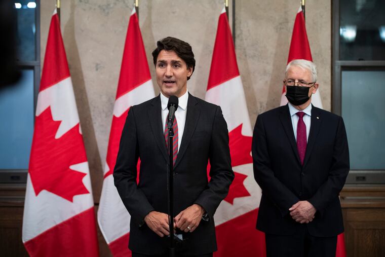 Prime Minister Justin Trudeau stands with Minister of Foreign Affairs Marc Garneau to announce that Canadians Michael Spavor and Michael Kovrig have been released from detention in China, on Parliament Hill in Ottawa, on Friday, Sept. 24, 2021.