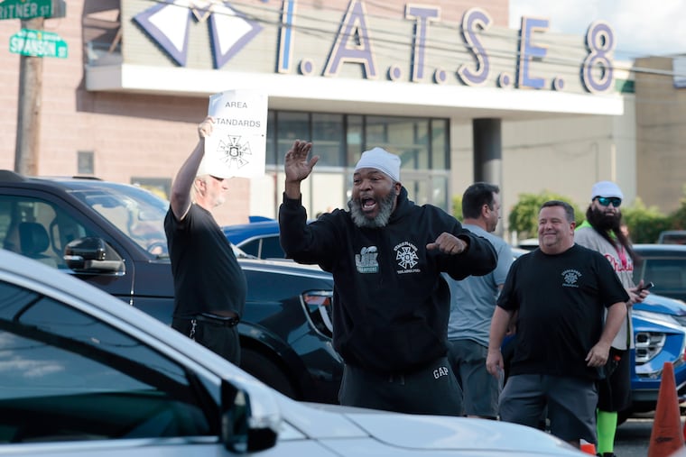 T.H. Styles (center) of Philadelphia, a 24-year stagehand, encourages people to honk their horns as IATSE (International Alliance of Theatrical Stage Employees) union members parade around the 2300 Arena in their cars in Philadelphia on Wednesday.