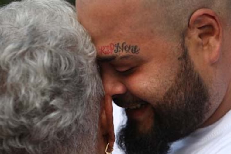 Jose Gonzalez hugs Doris Malevet before the beginning of the Vigil and march. Jose's brother Louis "Nene" Gonzalez was a victim, and Doris daughter Mita was also a victim. Vigil for Non Violence outside the home of Doris Malevet, mother of Mita Reyes at 830 N. 6th Street,Camden,NJ. ( RON CORTES / Staff Photographer ).