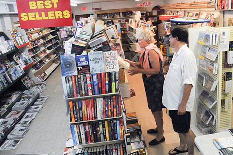 Liz McCaffrey looks at a book while husband Joe Serritella waits at The Paper Peddler in Avalon Sept. 9, 2014. The store has been a fixture in Avalon since 1968 but will be closing at the end of September 2014. ( CLEM MURRAY / Staff Photographer )