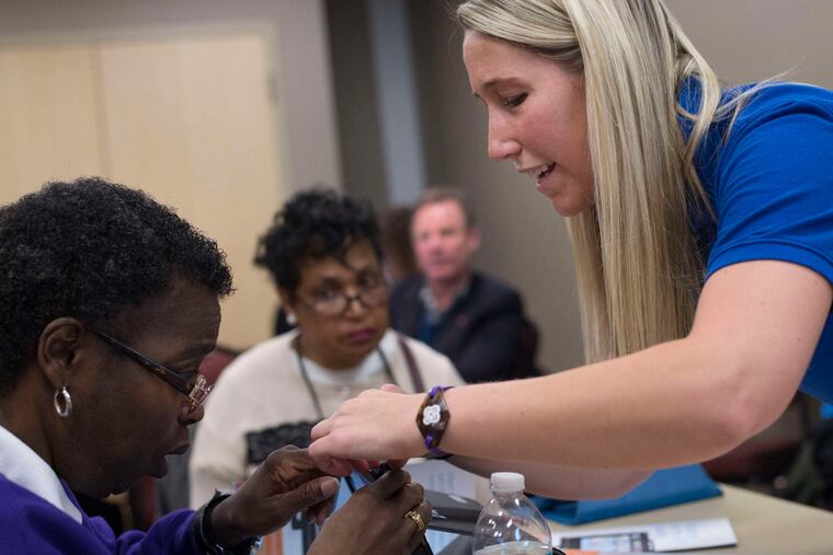 Lingraphica clinical consultant Brianne Kosch helps Carolyn Benson, of Philadelphia, use new software designed to help patients with aphasia during a support group session at Magee Rehabilition Center in Philadelphia, Pa. on Tuesday, Feb. 2, 2016. Aphasia can affect people of all ages with brain injury, including stroke victims.