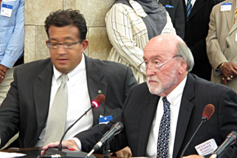 William Curry, executive director of the New Jersey Re-Entry Coalition, and John Clancy, CEO of Community Education Centers, testify before a state Senate committee in Trenton. GEOFF MULVIHILL / Associated Press