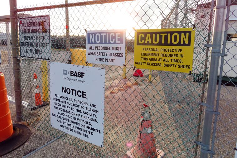 A gate at the entrance to the former Ciba Geigy chemical plant in Toms River, N.J., is filled with warning signs regarding the contaminated area, which is on the Superfund list of the nation's worst toxic waste sites. A proposed settlement to restore natural resources damaged by the company's dumping is widely opposed as insufficient by residents of Toms River, where childhood cancer rates from the late 1970s through 1990s occurred at elevated rates.